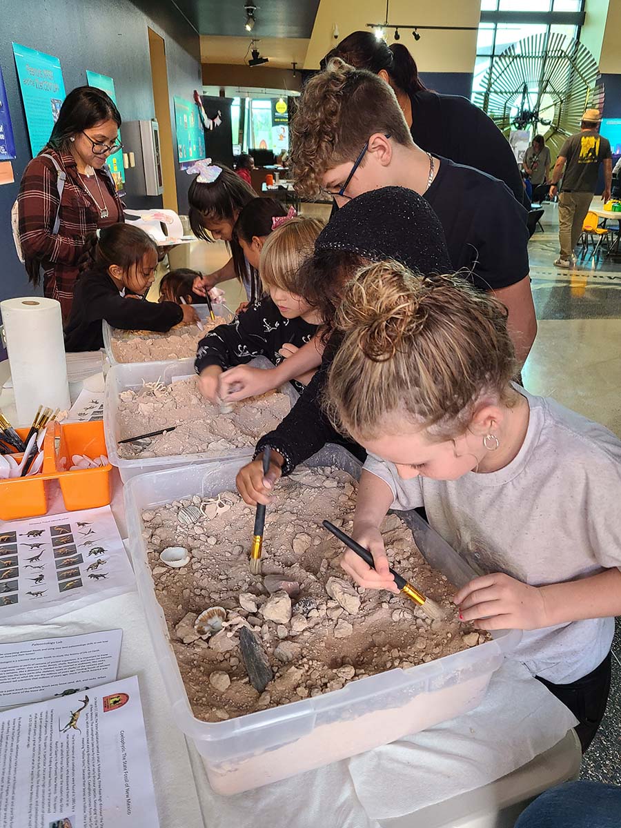 Students participating in a dinosaur dig