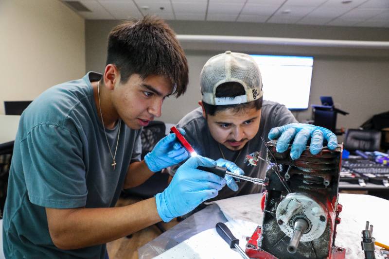 Boys in NSEP program working on engine.
