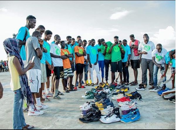 Gideon George with shoes in Africa